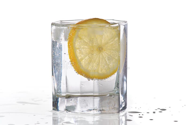Glass of water, ice and slice of fresh lemon royalty free stock photos