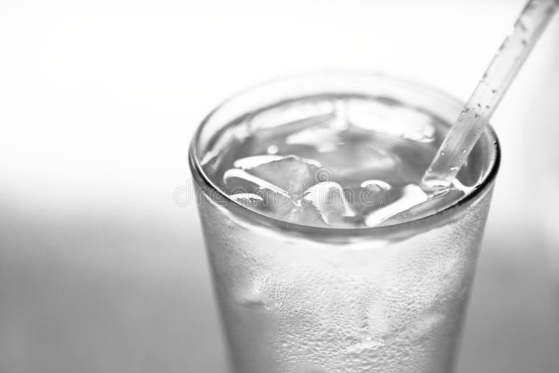 Glass with water, ice and straw