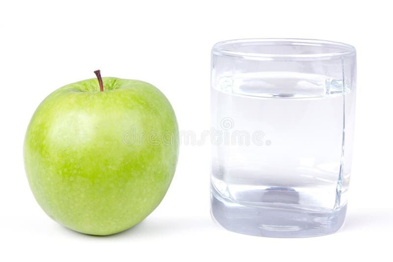 Glass of water and one green apple