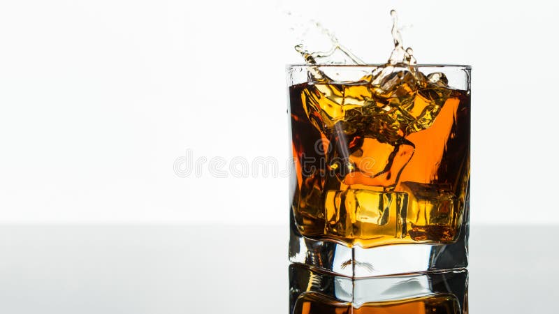 Glass of Whiskey, Bourbon or Brandy with Ice Cube on White Isolated  Background. Glass for Alcohol Drink Stock Photo - Image of macro, plastic:  215386878