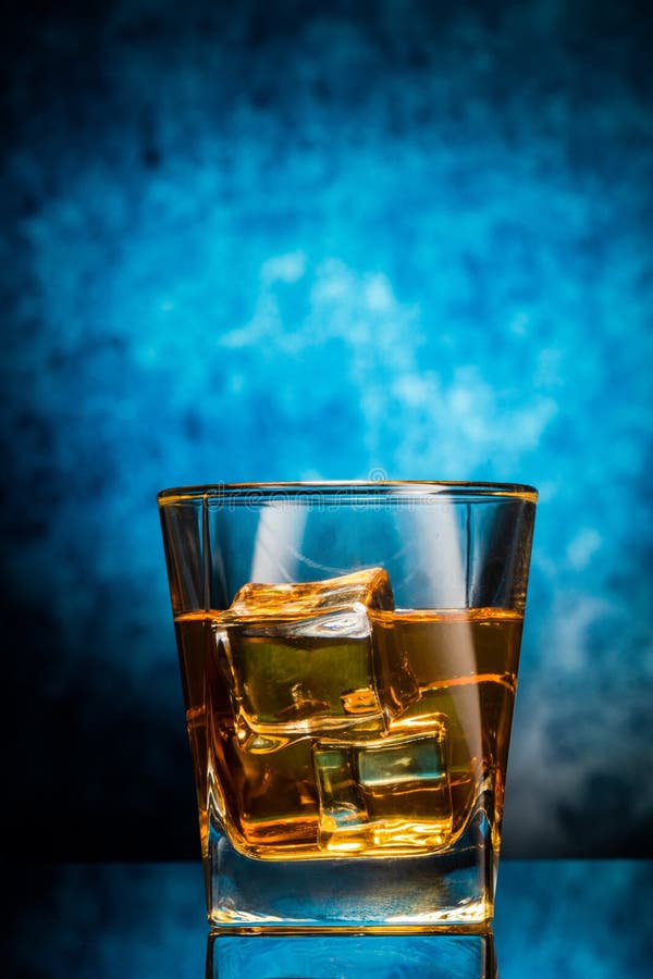 Glass of Whiskey on Blue Background Stock Image - Image of blue ...