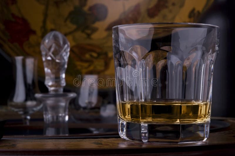 Crystal glass of whisky alcohol on a fancy bar