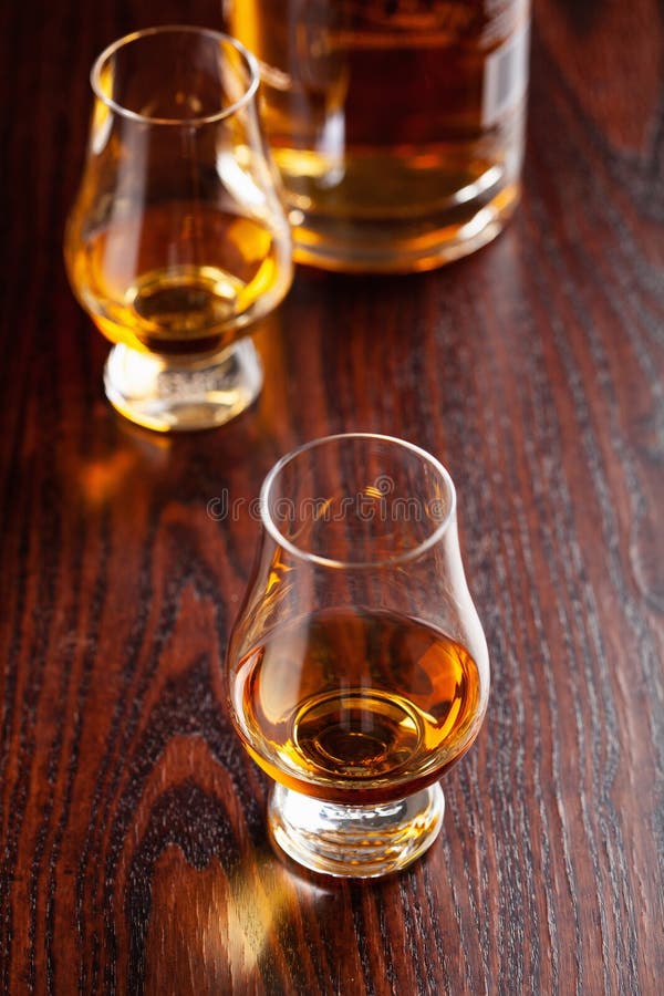 Glass of Whisky Spirit Brandy on Dark Brown Background Stock Image
