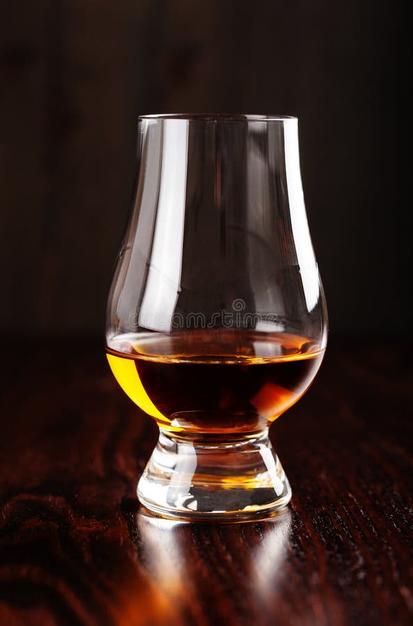 Glass of Whisky Spirit Brandy on Dark Brown Background Stock Image