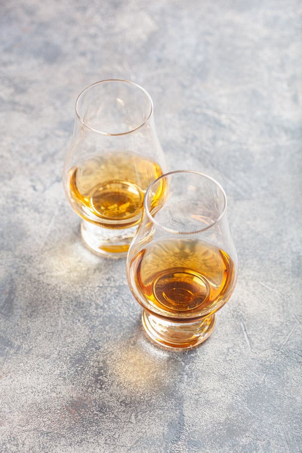Glass of Whisky Spirit Brandy on Gray Concrete Background Stock Photo