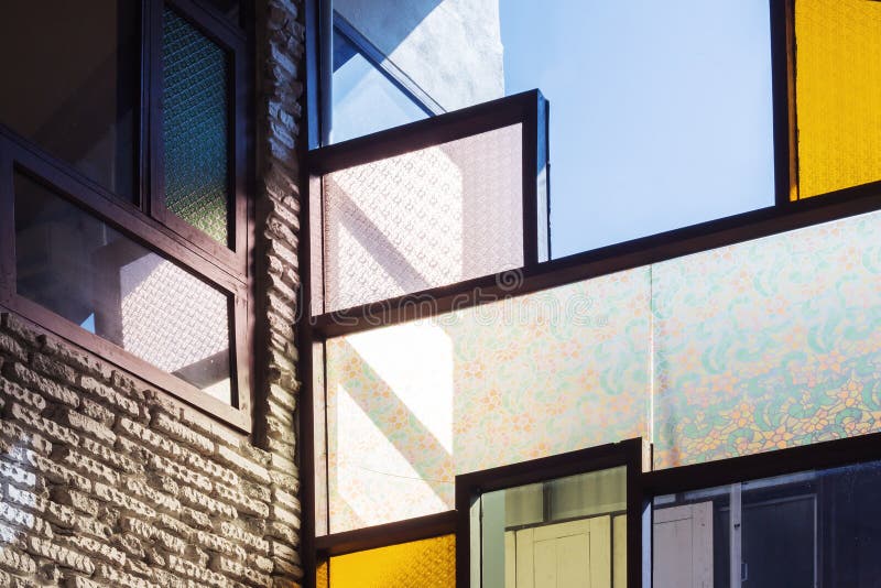 Glass and white brick wall in room with sunlight.