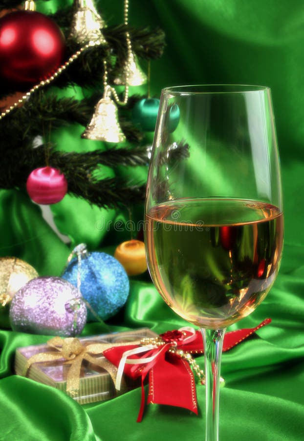 Glass of white wine on a beautiful christmas background