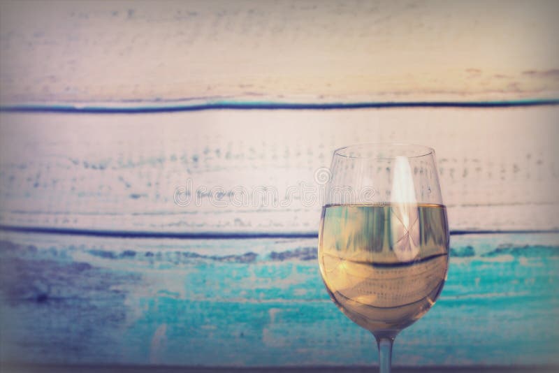 Glass of white wine being poured from bottle royalty free stock images
