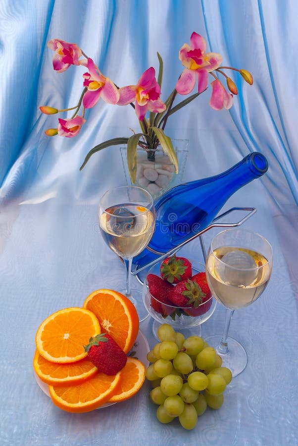 Glass of White Wine and Blue Bottle with Oranges Stock Photo Image of