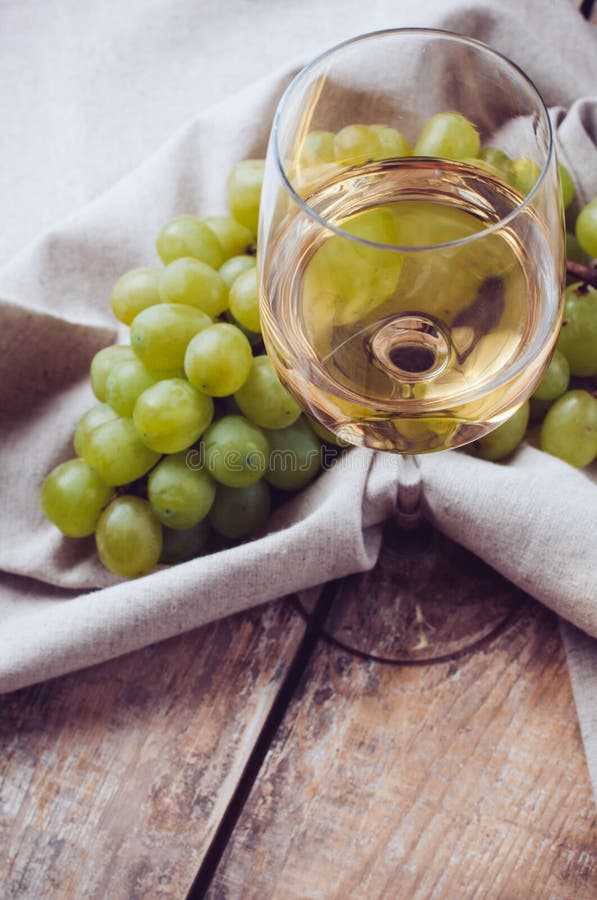 Glass of white wine and grapes