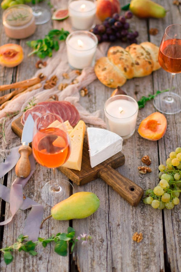 Glass of white wine on picnic table.