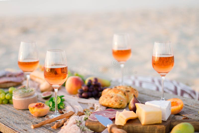 Glass of white wine on picnic table.