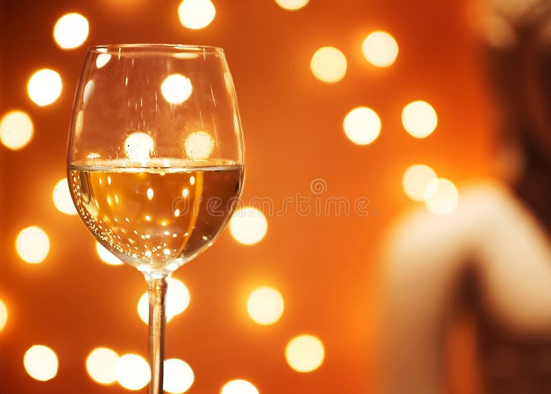 Glass of wine on a background of orange lanterns