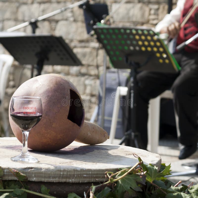 Glass of wine and a scoop from butternut squash on a barrel in Koilani village, Cyprus