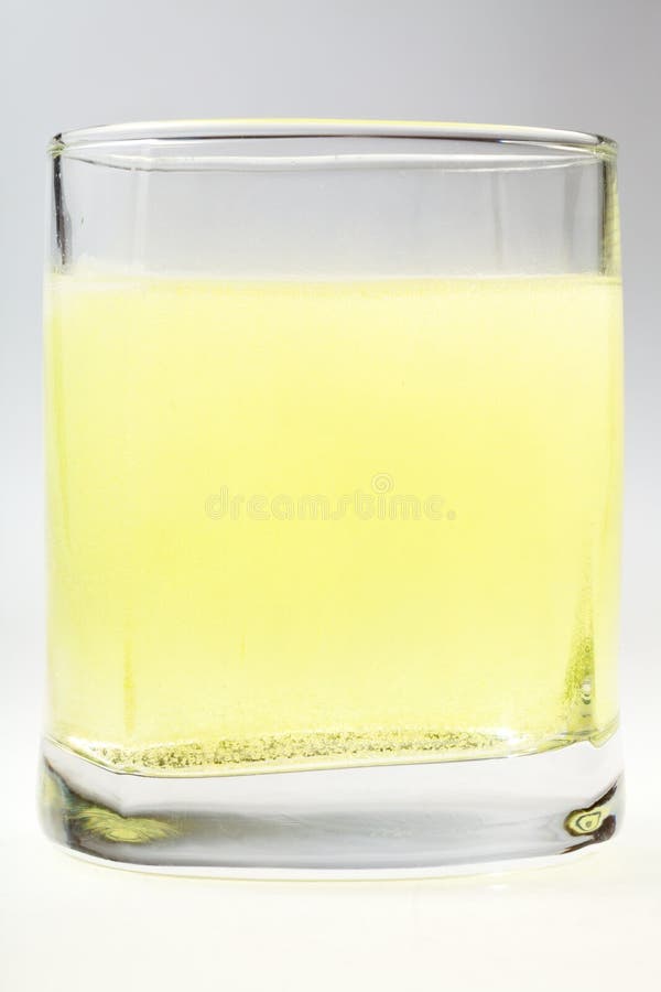 Glass of yellow carbonated water