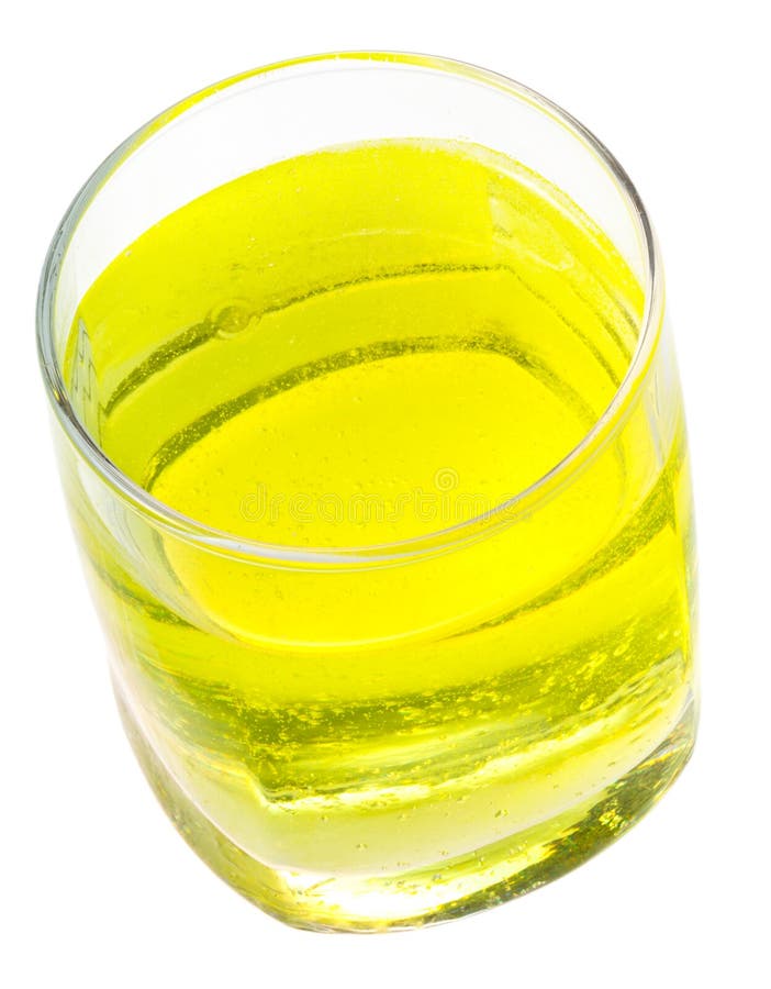 Glass of yellow carbonated water with vitamin