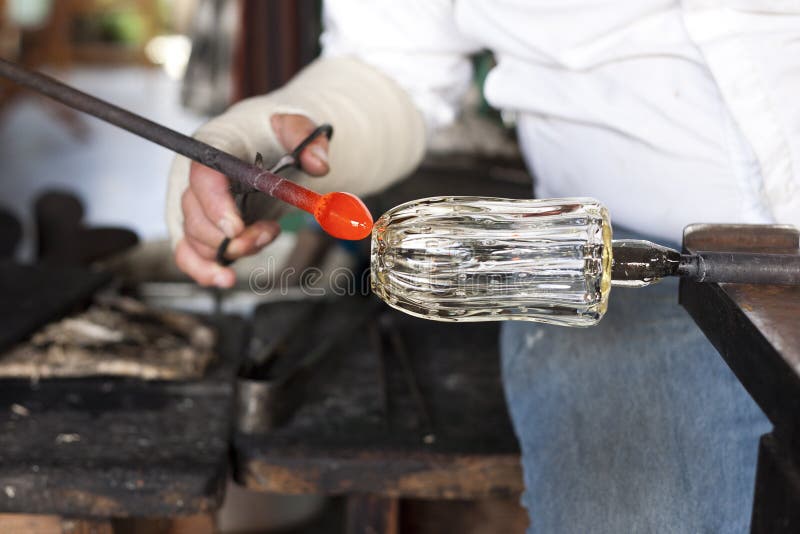 Glassblower shaping molten glass