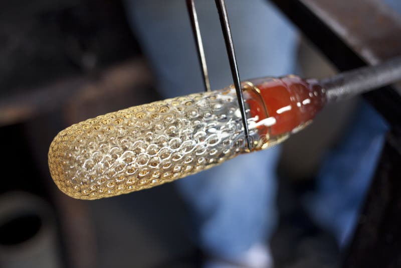 Glassblower shaping molten glass