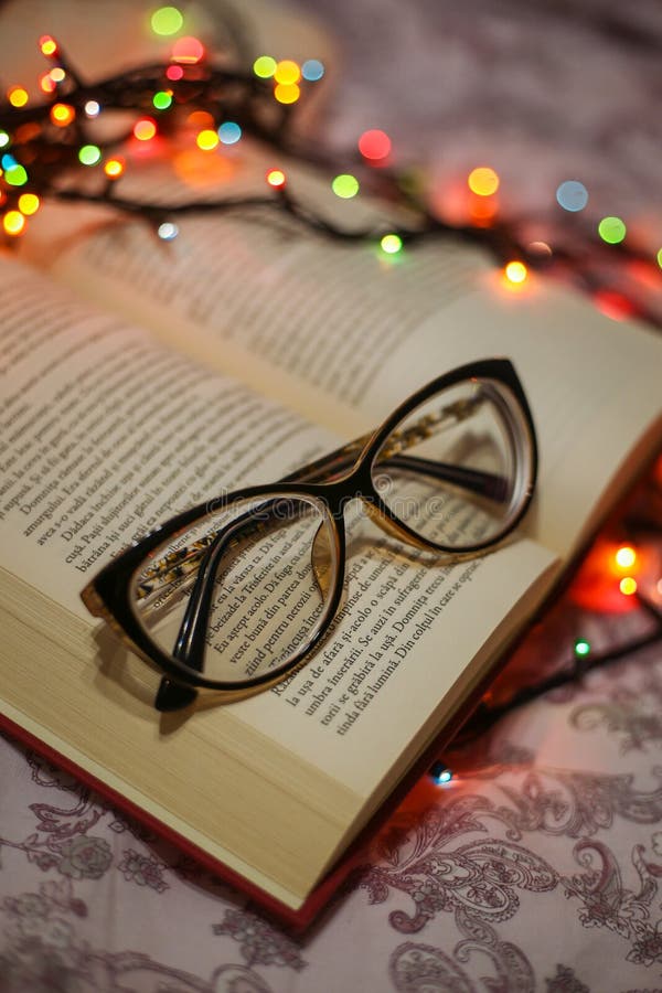 Glasses on book stock image. Image of cover, bokeh, closeup 172680659