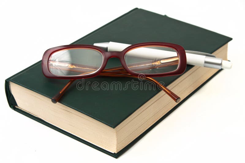 Glasses on book and pen