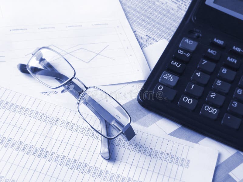 Glasses and calculator on financial documents.