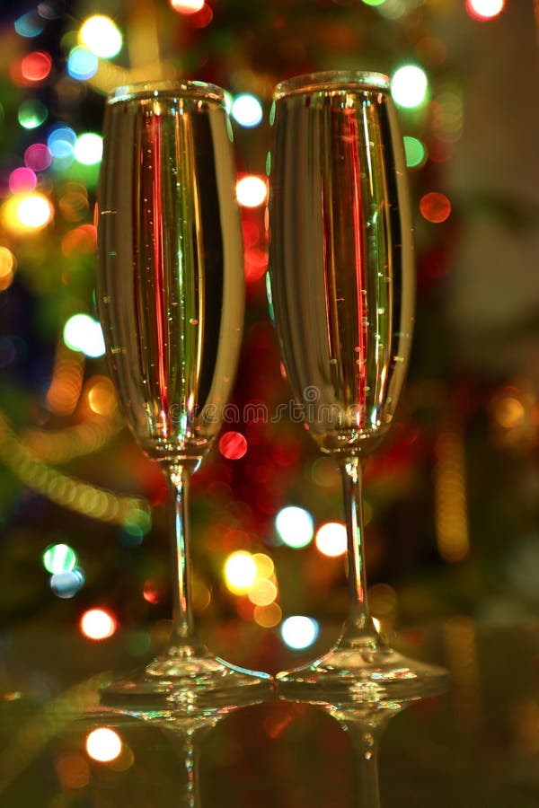 Glasses with champagne against festive lights stock photos Glasses with champagne against festive lights stock photos