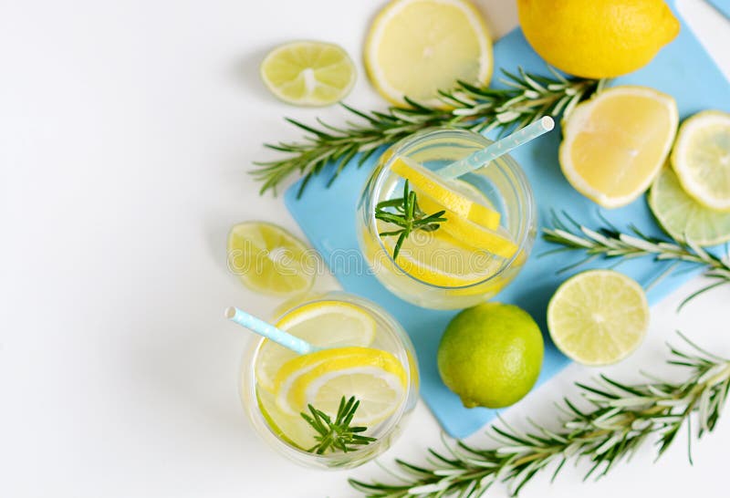 Glasses with Fresh Water Rosemary Lemon Lime Fruits