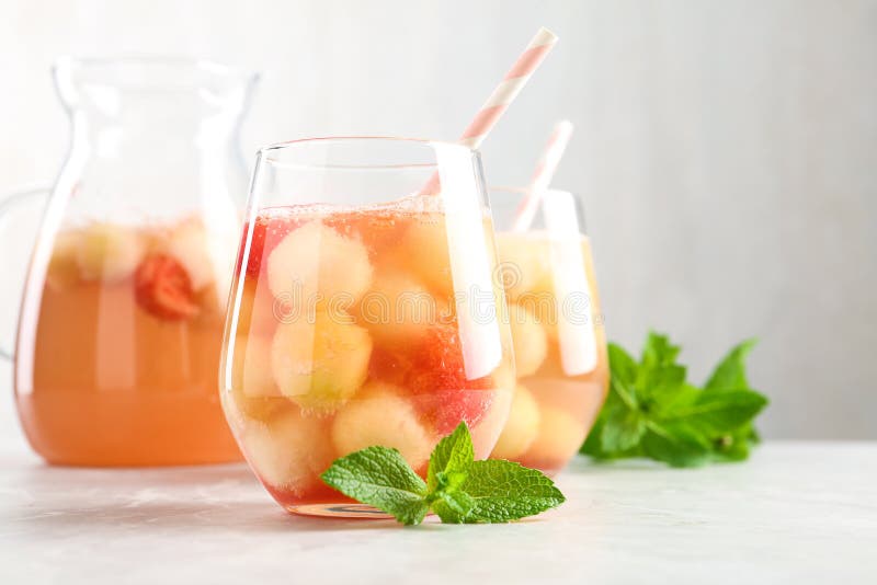 Glasses of Melon and Watermelon Ball Cocktail with Mint on Table Stock