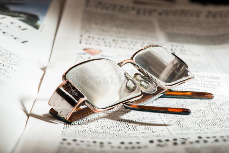 Glasses on newspaper