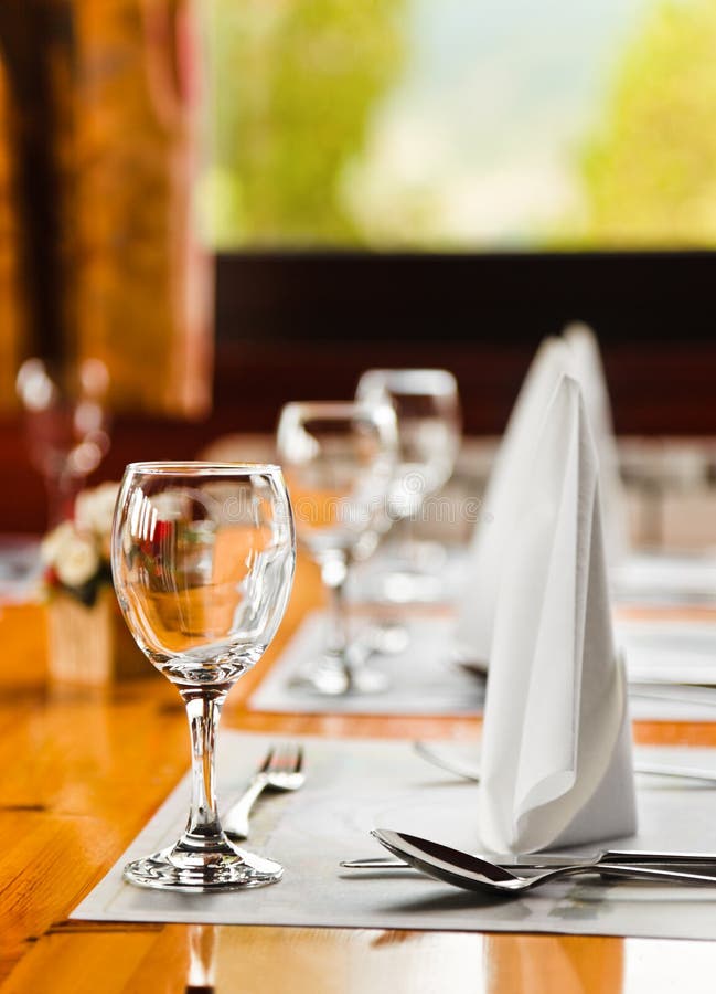 Glasses and plates on table in restaurant