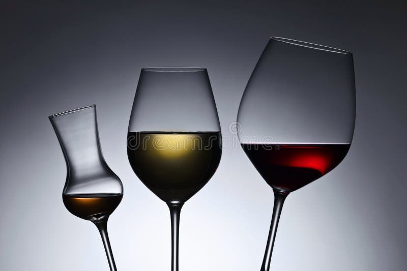 Glasses with red and white wine. Crystal, reflection.