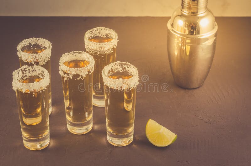 Glasses of Tequila and Pieces of Lime and Shaker/glasses of Tequila and