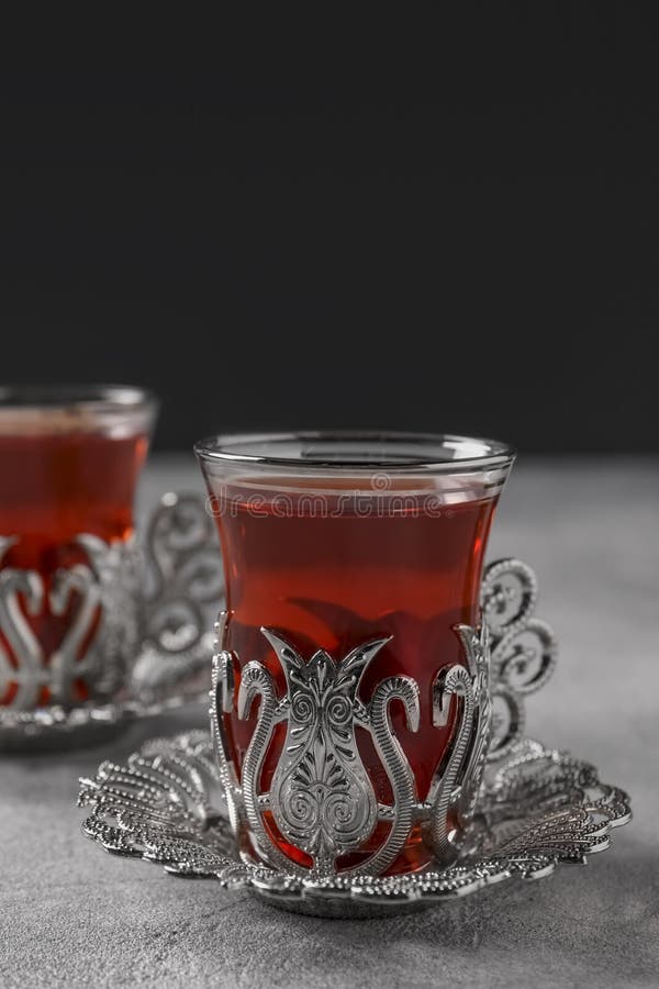 Glasses of Traditional Turkish Tea in Vintage Holders on Light Grey