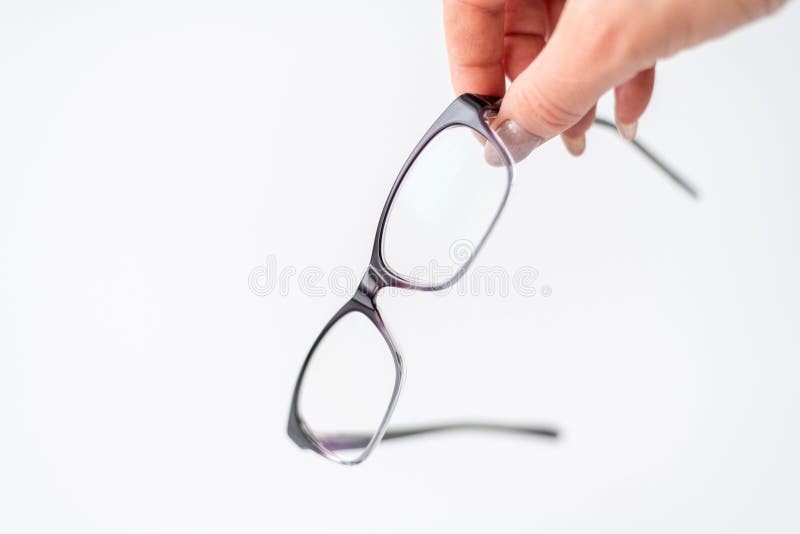 Glasses for Vision Correction in Female Hand on White Stock Photo