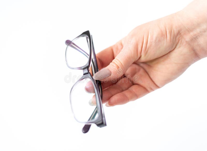 Glasses for Vision Correction in Female Hand on White Stock Image