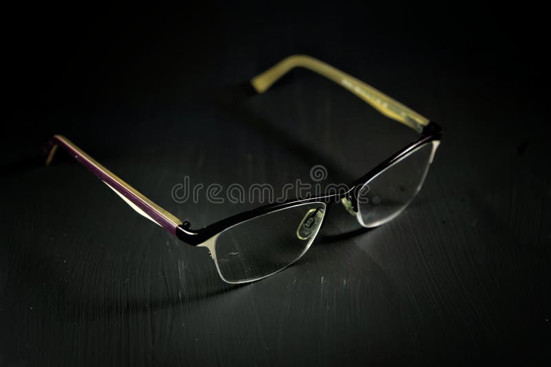 Glasses for Vision Correction Medical in a Thin Dark Frame on a Black