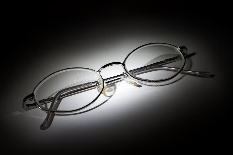 Glasses on white background in the darkness