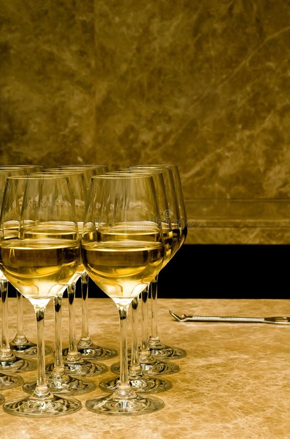 Glasses with white wine on marble