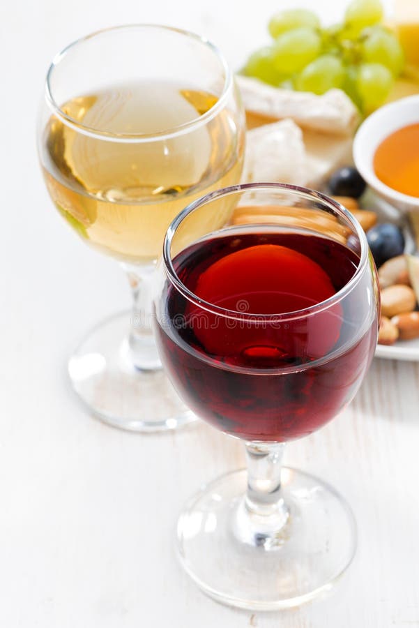 Glasses with wine and snacks on white table, closeup royalty free stock photography Glasses with wine and snacks on white table, closeup royalty free stock photography
