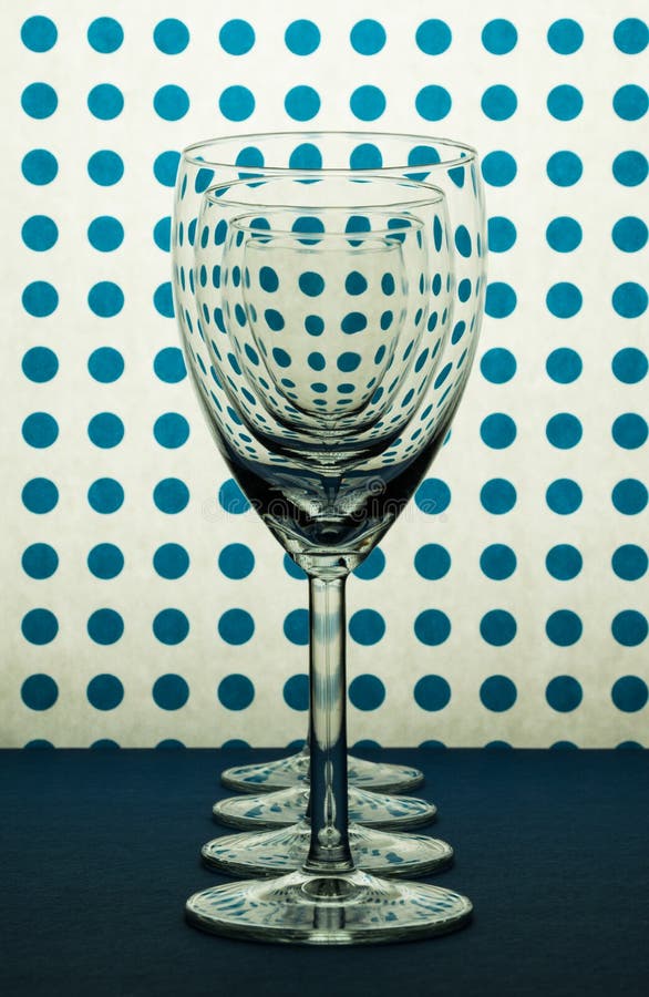 Four Transparent Wine Glasses Standing in Line and White Background