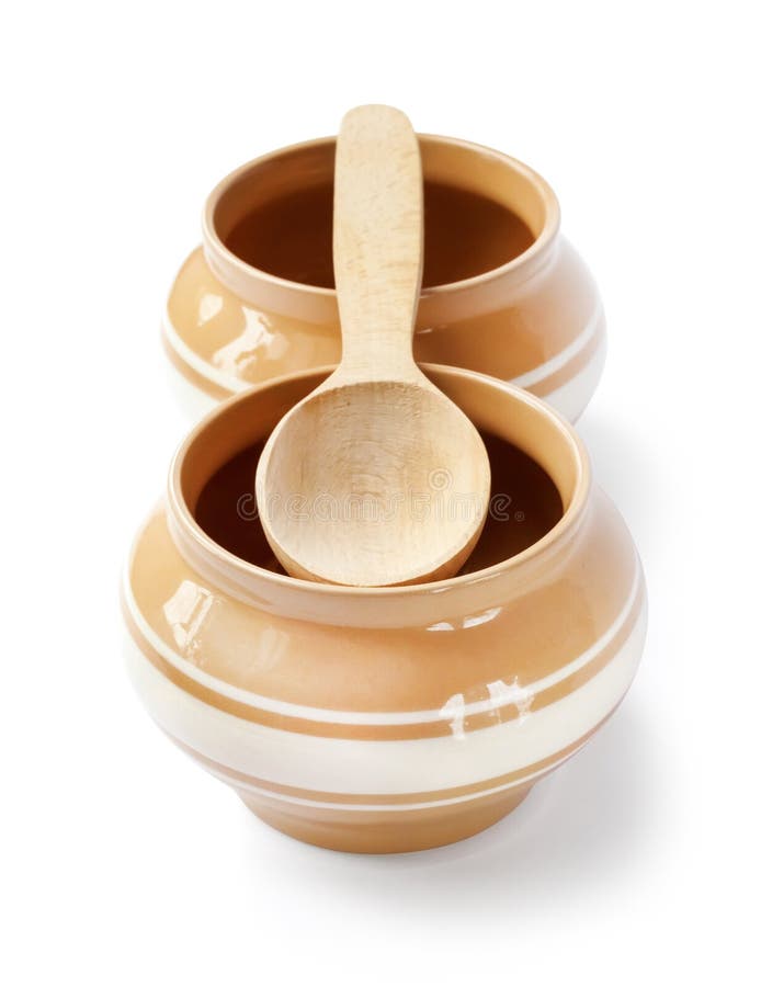 Glazed Ceramic Pots for Cooking with Wooden Spoon on a White Background