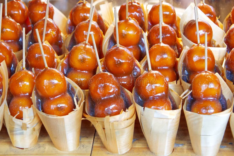 Glazed fruit as desser at the street market. Glazed japanese fresh fruit as desser at the street market