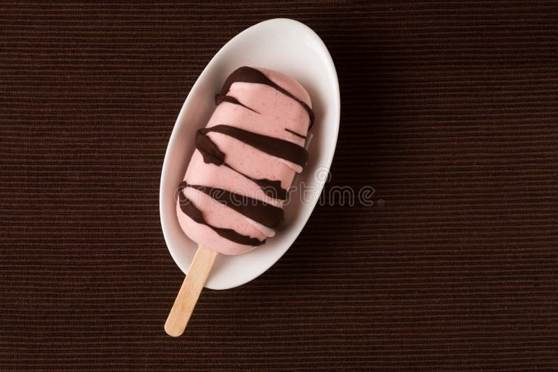 Top view of homemade fresh glazed strawberry and chocolate ice popsicle