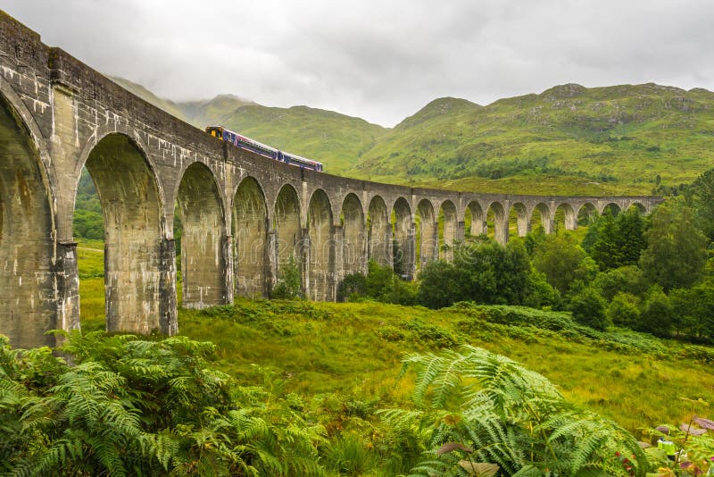 Glenfinnan Viaduct from side on cloudy day with passing train stock image