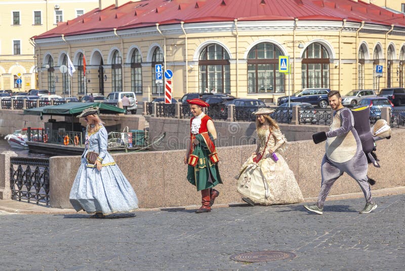 SAINT PETERSBURG, RUSSIA - June 07.2019: A group of animators go to the location of filming in the historic part of the city. SAINT PETERSBURG, RUSSIA - June 07.2019: A group of animators go to the location of filming in the historic part of the city