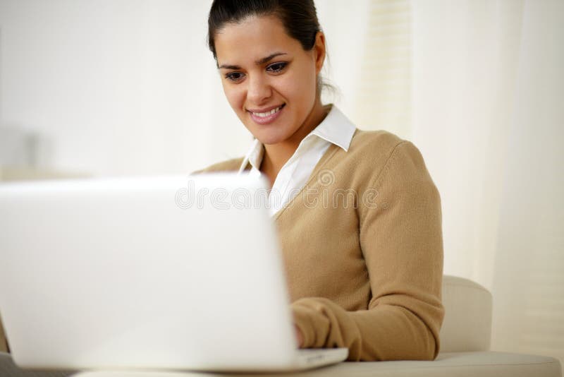 Portrait of a smiling young female working with laptop computer. Portrait of a smiling young female working with laptop computer