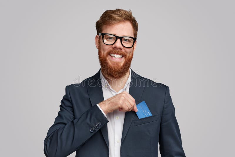 Glimlachende gebaarde mens die creditcard in zak tonen stock fotografie Glimlachende gebaarde mens die creditcard in zak tonen stock fotografie