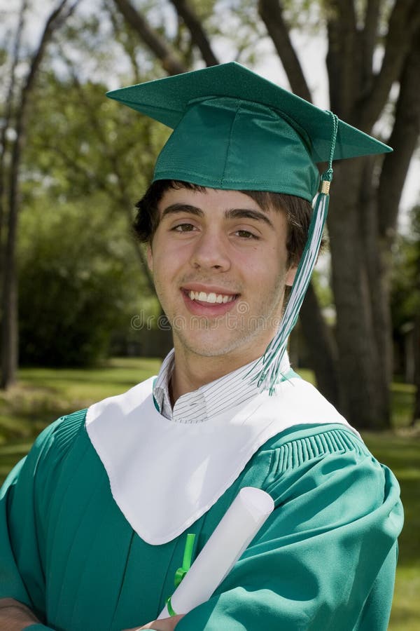 A happy young graduate, smiling & proudly holding his degree. A happy young graduate, smiling & proudly holding his degree.