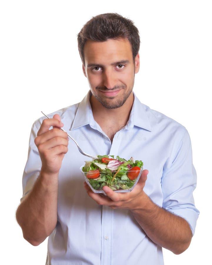 Glimlachende Latijnse mens die salade eten royalty-vrije stock afbeelding Glimlachende Latijnse mens die salade eten royalty-vrije stock afbeelding