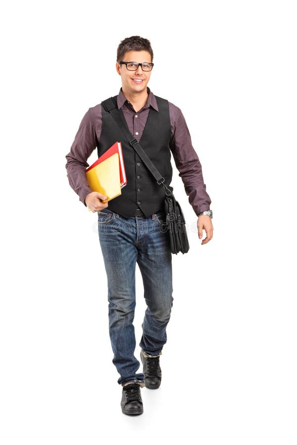 Glimlachende schooljongen die en boeken loopt houdt stock foto's Glimlachende schooljongen die en boeken loopt houdt stock foto's